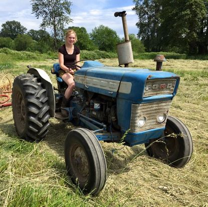 Cathy raking hay